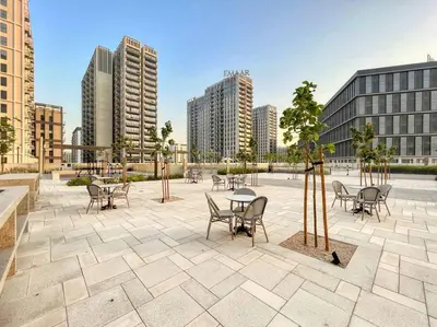 a patio with tables and chairs in a city at 2bedroom apartment Dubai Hills in Dubai