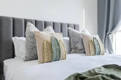 a white bed with pillows on top of it at 2bedroom apartment Dubai Hills in Dubai