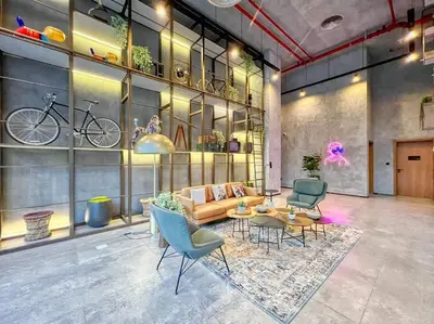 a living room with a couch and a table and chairs at 2bedroom apartment Dubai Hills in Dubai