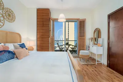 a bedroom with a large bed and a balcony at Boutique Apartment Sea Views - Dubai Marina in Dubai