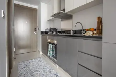 a kitchen with a sink and a counter top at Frank Porter - Damac Prive B in Dubai