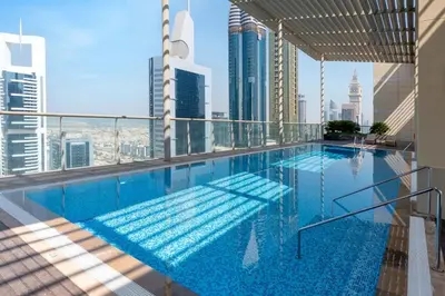 a swimming pool on the top of a building at Upgraded 1BR on a high floor of Liberty House,DIFC - Allsopp&Allsopp in Dubai