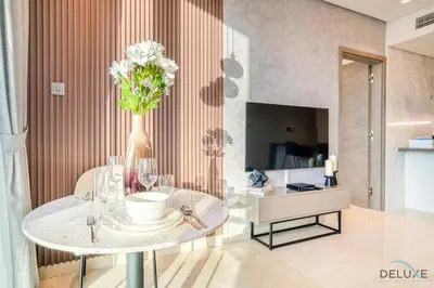 a living room with a table with a vase of flowers at Exclusive Offer Cozy Stay with Burj Khalifa Views by Deluxe Holiday Homes in Dubai