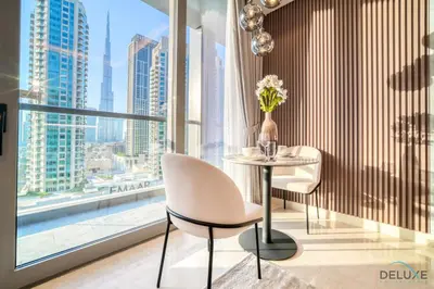 a table and two chairs in a room with a large window at Exclusive Offer Cozy Stay with Burj Khalifa Views by Deluxe Holiday Homes in Dubai