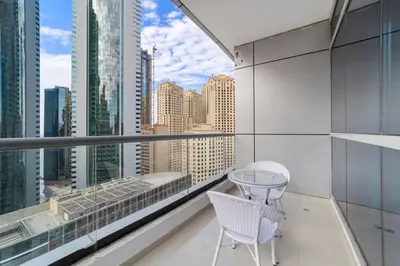 a balcony with a table and chairs and a view of the city at StoneTree - Near JBR Beach - Prime Location in Dubai