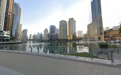 a river in a city with tall buildings at StoneTree - Near JBR Beach - Prime Location in Dubai