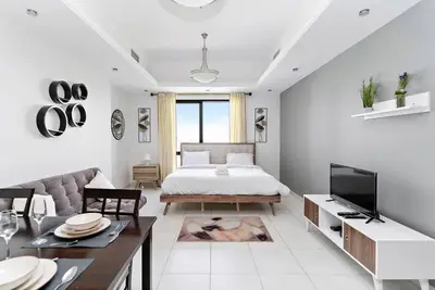 a living room with a bed and a couch at StoneTree - Near Metro - Furnished Studio in JLT in Dubai