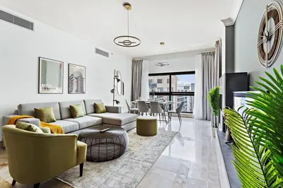 a living room with a couch and a table at StoneTree - Elegant 2BR with 1 Maids Room in Dubai