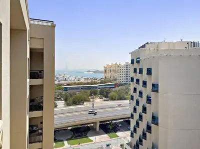 a view of a city with a train on a highway at StoneTree - Elegant 2BR with 1 Maids Room in Dubai