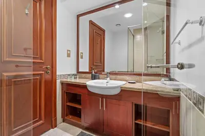 a bathroom with a sink and a mirror at StoneTree - Elegant 2BR with 1 Maids Room in Dubai