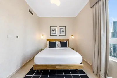 a bedroom with a bed and a large window at Durrani Homes - Grandiose 5BR Besides Dubai Mall with Burjkhalifa and Fountain view in Dubai