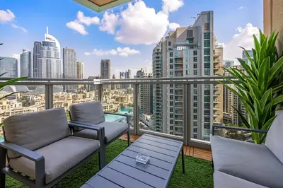 a balcony with chairs and a view of the city at Durrani Homes - Lavish 3BR Besides Burj Khalifa and Fountain view in Dubai