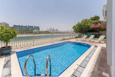 a swimming pool with a view of the water at 6 Bedroom Modern Luxury Villa In Palm Jumeirah in Dubai
