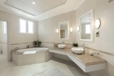 a white bathroom with two sinks and a tub at 6 Bedroom Modern Luxury Villa In Palm Jumeirah in Dubai