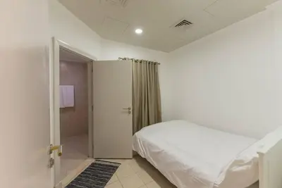 a white bedroom with a bed and a shower at 6 Bedroom Modern Luxury Villa In Palm Jumeirah in Dubai