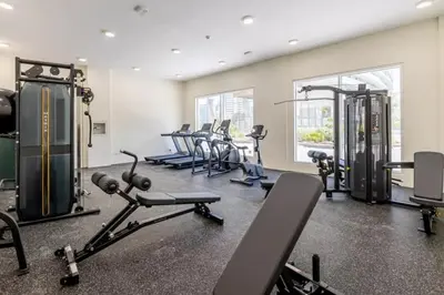 a gym with a bunch of treadms and cardio machines at Bright & Elegant Studio Balcony Speedy Wi-Fi in Dubai