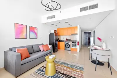 a living room with a couch and a table at StoneTree - Modern Stylish Studio in JLT in Dubai