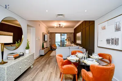 a dining room and living room with a table and chairs at Luxury Escapes - Newly furnished 1BR Apartment - 8 BLVD WALK DOWNTOWN in Dubai