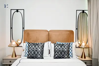 a bedroom with a bed with pillows and two lamps at Luxury Escapes - Newly furnished 1BR Apartment - 8 BLVD WALK DOWNTOWN in Dubai