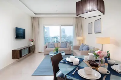 a living room with a table and a couch at Lovely Lake View - Two Bedroom - JLT in Dubai