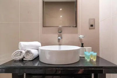 a bathroom with a sink and towels on a counter at Lovely Lake View - Two Bedroom - JLT in Dubai