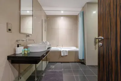 a bathroom with a sink and a bath tub at Lovely Lake View - Two Bedroom - JLT in Dubai