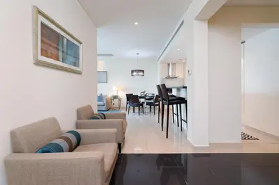 a living room with a couch and a dining room at Lovely Lake View - Two Bedroom - JLT in Dubai