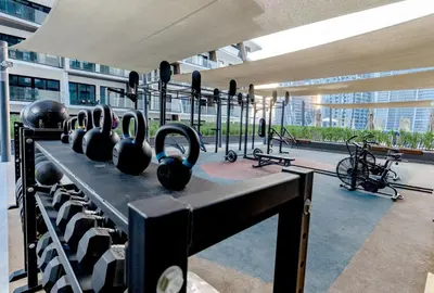 a gym with black exercise equipment in a building at Cozy Studio whit balcony 15NS in Dubai