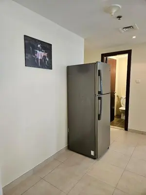 a refrigerator in a room with a picture on the wall at Lakeshore Towers, Cluster Y , JLT, 1BHK in Dubai