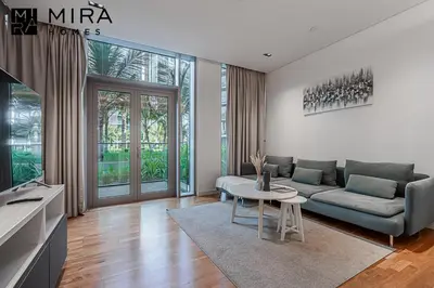 a living room with a couch and a table at Mira Holiday Homes - Serviced 1 bedroom in Bluewaters in Dubai