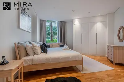 a bedroom with a large bed and a window at Mira Holiday Homes - Serviced 1 bedroom in Bluewaters in Dubai