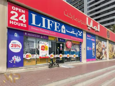 a store front of a store with signs on it at Marco Polo - Relax in a modern 1BR in Dubai Marina in Dubai