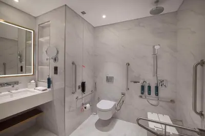 a bathroom with a toilet and a shower and a sink at Hilton Garden Inn Dubai Business Bay in Dubai