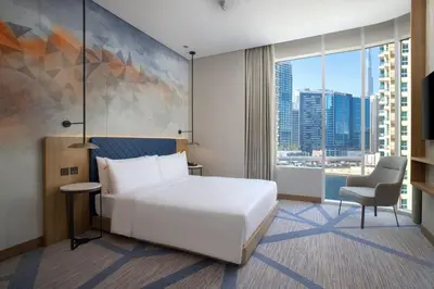 a hotel room with a white bed and a window at Hilton Garden Inn Dubai Business Bay in Dubai
