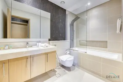 a bathroom with a sink and a toilet and a mirror at Sleek 1BR at 5242 Tower 1 Dubai Marina by Deluxe Holiday Homes in Dubai