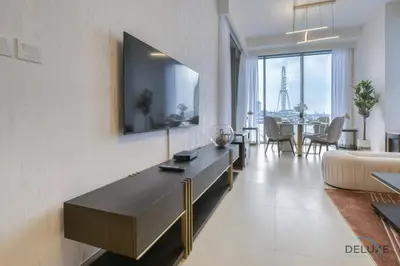 a living room with a couch and a television on a wall at Sleek 1BR at 5242 Tower 1 Dubai Marina by Deluxe Holiday Homes in Dubai