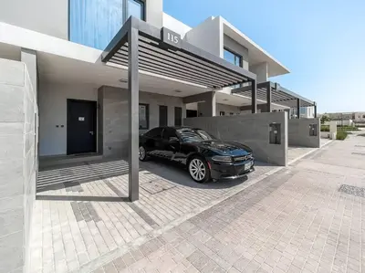 a black car parked in front of a house at StoneTree - 3 BR with 1 Maids Room Villa in Camelia - Arabian Ranches in Dubai