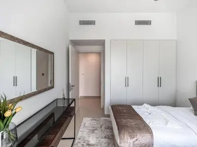 a bedroom with a large bed and a mirror at StoneTree - 3 BR with 1 Maids Room Villa in Camelia - Arabian Ranches in Dubai