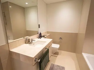 a bathroom with a sink and a toilet and a mirror at MH - ACT TOWER - Downtown -1Bedroom Apartment - REF504 in Dubai