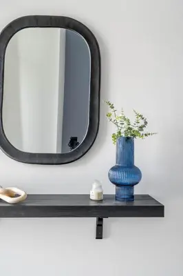 a blue vase on a shelf in front of a mirror at GuestReady - Majestic canal and Burj Khalifa view in Dubai
