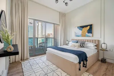 a bedroom with a large bed and a large window at GuestReady - Modernity elegance in Dubai Marina in Dubai