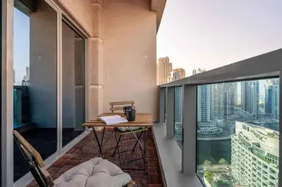a balcony with a table and chairs on a building at GuestReady - Modernity elegance in Dubai Marina in Dubai