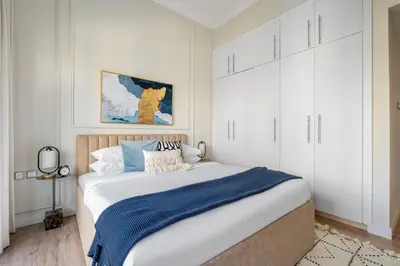 a bedroom with a large bed with white cabinets at GuestReady - Modernity elegance in Dubai Marina in Dubai