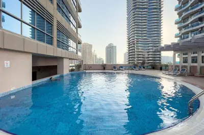 a large swimming pool in the middle of a building at GuestReady - Modernity elegance in Dubai Marina in Dubai