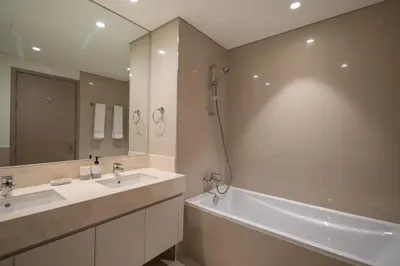 a bathroom with a tub and a sink and a bath tub at MH - ACT Tower -Downtown- 2Bedrooms - REF 408 in Dubai