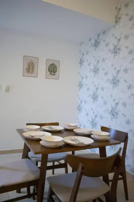 a dining room with a wooden table and chairs at Your Silicon Oasis Escape-1BHK in Dubai