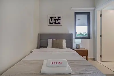 a bedroom with a bed with a scale on it at Brand New Luxurious 4BR & Maid Room Townhouse in Dubail Hill Estate in Dubai