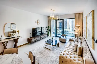 a living room with a couch and a tv at Elegant 3BD family home in Marina Vida Residence in Dubai
