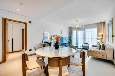 a living room with a table and a couch at Elegant 3BD family home in Marina Vida Residence in Dubai