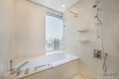 a bathroom with a bath tub and a window at Marina Canal Views 2BR Unit Next to Marina Mall, The Address Residences, Dubai Marina by Deluxe Holiday Homes in Dubai